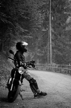 black and white photograph of a person on a motorcycle