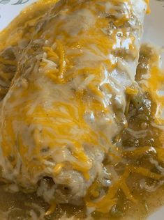 two enchiladas covered in gravy on a plate