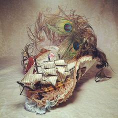 a boat with feathers on it sitting on top of a table