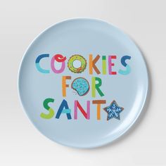 a blue plate with the words cookies for santa written in multicolored letters on it