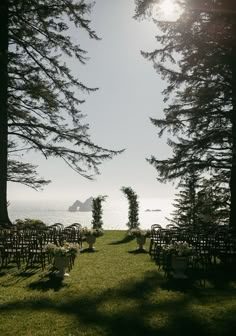 an outdoor ceremony set up with chairs and trees