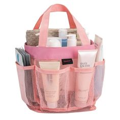 a pink mesh bag filled with cosmetics and personal care items on top of a white background