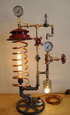 a lamp that is sitting on top of a wooden table next to a clock and some wires