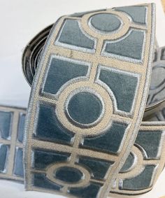 a close up of a tie with circles and squares on the front, along with other ties