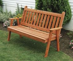 a wooden bench sitting in the grass