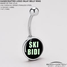 a black and green glow belly ring with the words ski bid on it's side