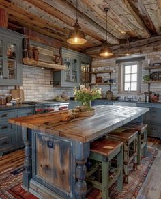 an old fashioned kitchen with wooden floors and blue cabinetry is featured in this image