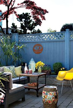 an outdoor patio with yellow chairs and tables