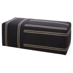 a black and white ottoman cover with stripes on the bottom, sitting in front of a white background