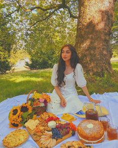 a woman sitting in front of a table filled with food