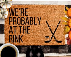 a door mat that says, we're probably at the rink with hockey sticks and pumpkins