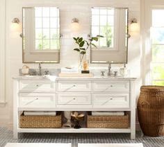 a bathroom with two sinks, mirrors and wicker baskets on the floor in front of it