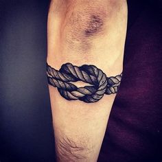 a man's arm with a tattoo on it that has a rope wrapped around it