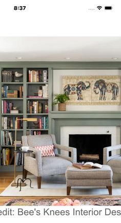 a living room filled with furniture and a fire place in front of a book shelf