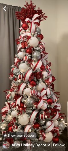 a christmas tree decorated with red and white balls, candy canes, and bows