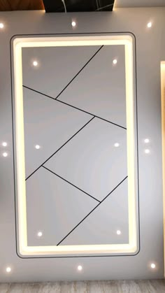 a mirror that is on the wall with lights around it and a light up frame