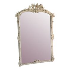 an ornate white framed mirror with flowers on the top and bottom edge, against a white background