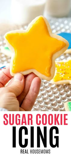 a hand holding a sugar cookie with icing on it and the words, sugar cookie icing real house moms