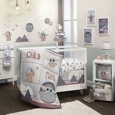 a baby crib bedding set in a child's room with pictures on the wall