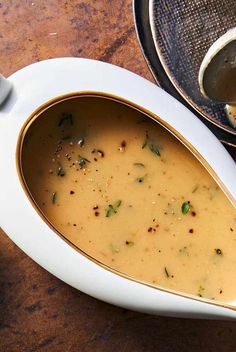 a bowl filled with soup sitting on top of a wooden table