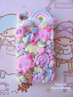 a cell phone covered in lots of different types of candies and toppings on it