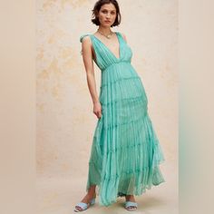 Just As Effortless As It Is Ethereal, This Stunning Maxi Gown Is Featured In A Gorgeous, Drapey Design With Deep V-Neckline, Tiered Bottom Skirt, And Metallic Threading Throughout For An Added Special Touch. Fit: Flowy, Relaxed Fit Features: V-Neckline, Shoulder Ties, Empire Waist, Dropped Armholes, Tiered Silhouette, Fully Lined Style Why We <3 It: Shine Bright In This Stunning Maxi Dress Designed To Turn Heads At Absolutely Any Special Event. Fp One Old World Embellishment With A Modern Twist. Maxi Dress Designs, Maxi Gown, Empire Waist Dress, Maxi Gowns, Threading, Free People Dress, Shine Bright, Empire Waist, Blue Dress