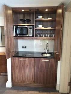 an open refrigerator freezer sitting inside of a kitchen next to a counter top oven