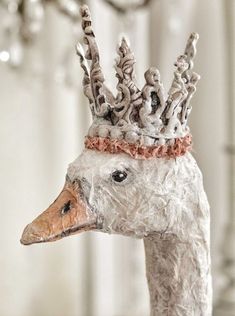 a close up of a statue of a duck wearing a crown