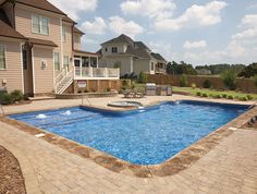 an empty swimming pool in the middle of a backyard with steps leading up to it