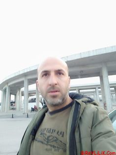 a man standing in front of a parking lot