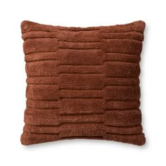 a brown pillow on a white background