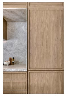 a bathroom with marble counter tops and wooden cabinets