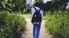 a person with a backpack walking down a path