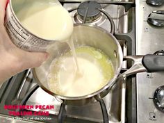 someone is pouring milk into a pot on the stove