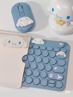 a blue and white keyboard sitting on top of a table next to a mouse pad