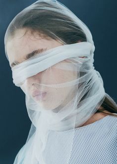 a woman wearing a veil over her face