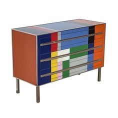 a multicolored cabinet with metal legs and drawers on each side that has different colors