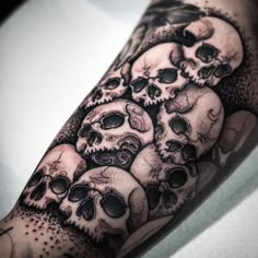 a man's arm with many skulls on it