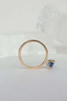 Blue sapphires come in all shades and clarity - this oval-shaped gem is wonderfully clear and sparking, with a rich, deep shade of blue that can change to more purple in different lighting. We've set this sapphire in a simple, airy prong with two tiny white diamonds under it. The overall effect is one of whimsy and delicacy, but this ring will be an heirloom for generations. - 1.45ct sapphire﻿- 0.03ctw diamonds﻿- 14k recycled yellow gold﻿- 2mm band﻿- High polish finish ﻿This ring ships immediate Cleaning Stone, Hanging Necklaces, Blue Sapphire Rings, White Diamonds, Diamond White, Shades Of Blue, Sapphire Ring, Blue Sapphire, Mars