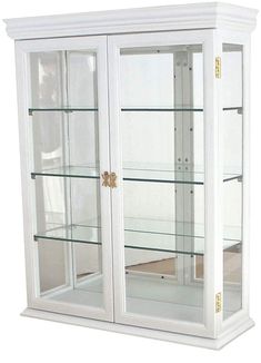 a white display case with glass doors and gold trimmings on the bottom shelf