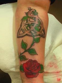 a woman with a rose tattoo on her arm