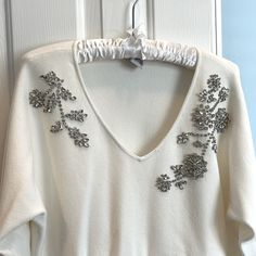 Beautiful But Understated Holiday Sweater. Ivory With Silver Rhinestone Design. Gems Are Sewn In, Not Just Glued. Rayon/Poly Blend Can Be Hand Washed. Gorgeous And Soft, Never Worn. Chicos Size 1. If Paying Full Price I Will Include The Satin, Padded Hanger. Padded Hangers, Holiday Sweater, Rhinestone Designs, Silver Rhinestone, Colorful Sweaters, Sweaters For Women, Gems, Satin, V Neck