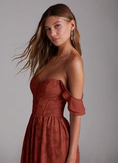 a woman in an off the shoulder dress