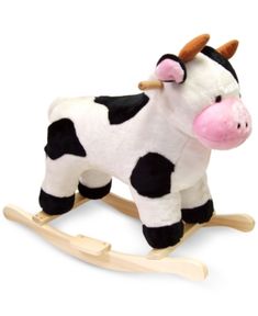 a black and white cow on a wooden rocking toy