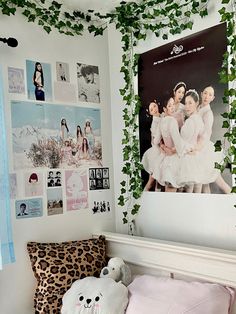 a bedroom decorated in pink and white with pictures on the wall