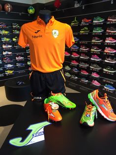 an orange shirt and green shoes are on display