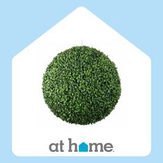 a round bush with the words at home on it in front of a blue background