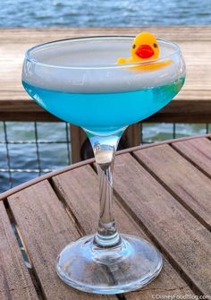 a blue cocktail with a rubber ducky on the rim