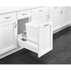 an open cabinet door in a kitchen with dark wood flooring and white cupboards