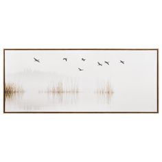 there are birds flying over the water and reeds in the foggy lake area